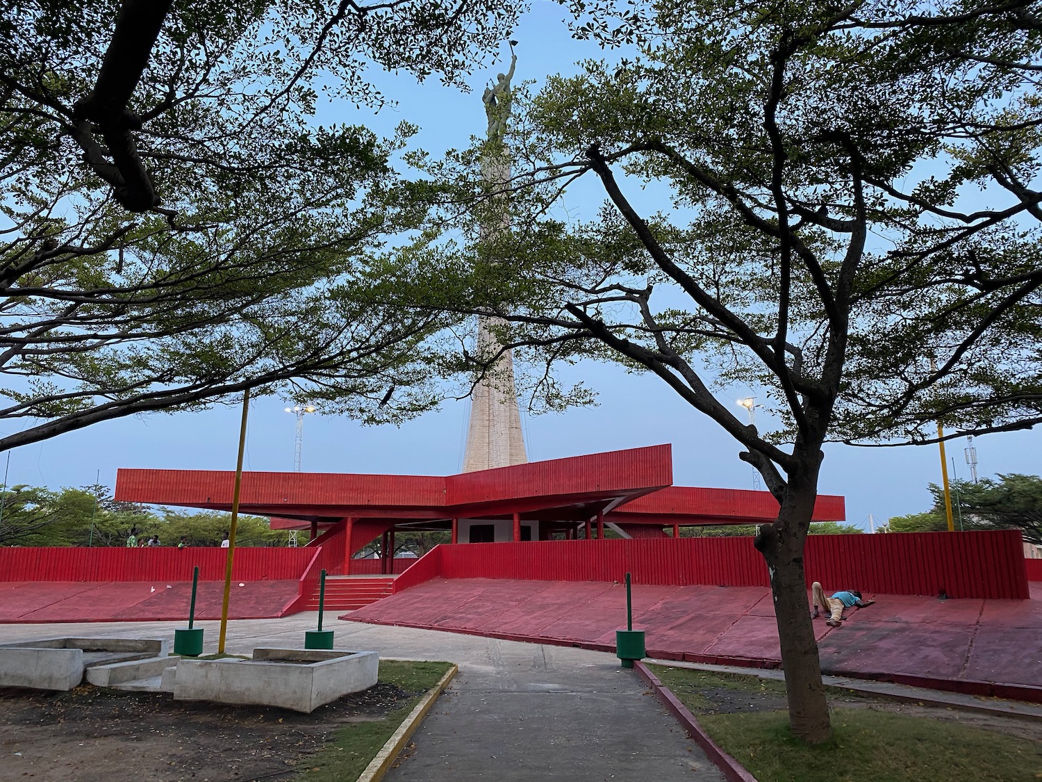 a red building with a tower in the background