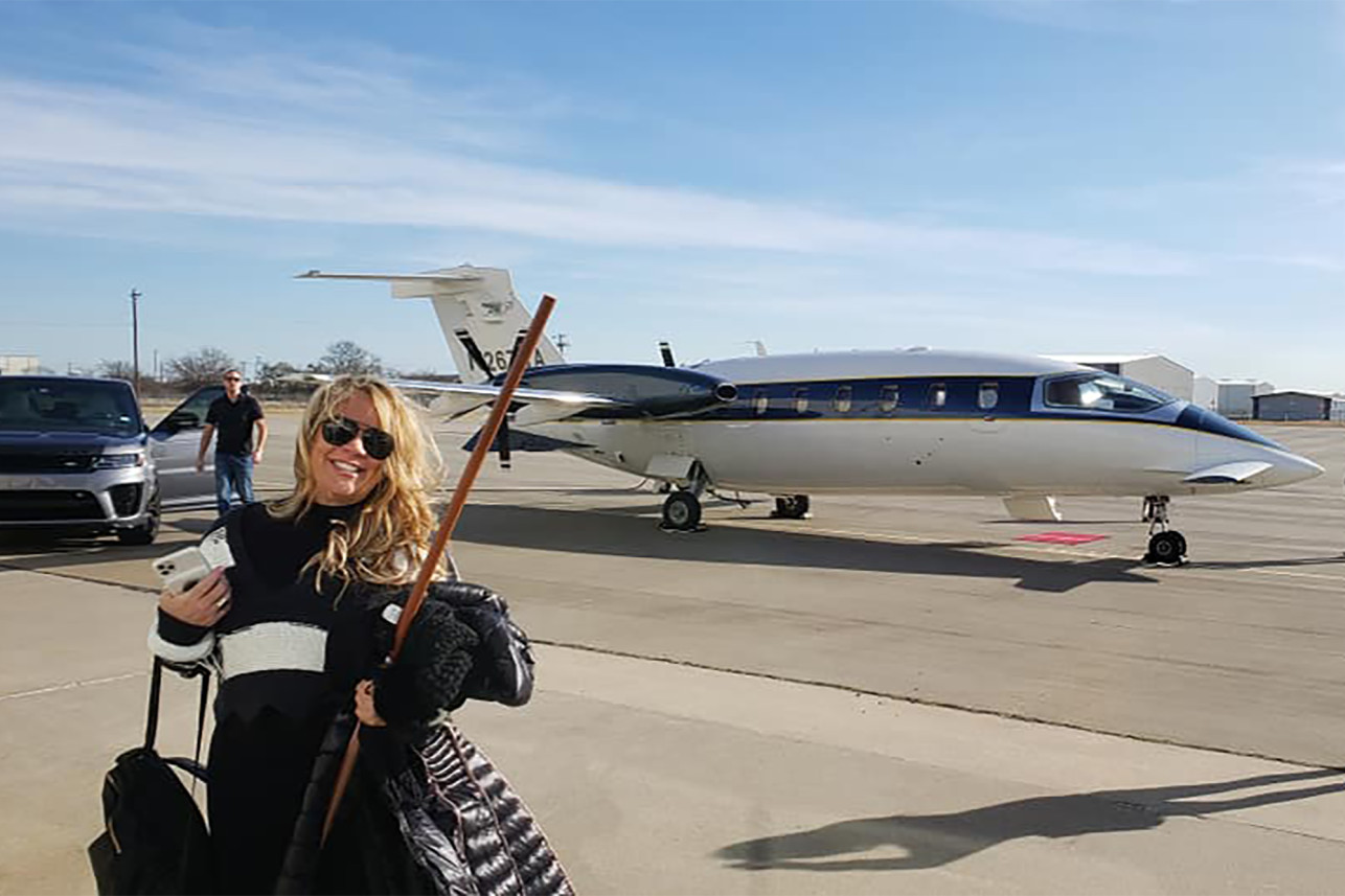 a woman standing in front of a plane