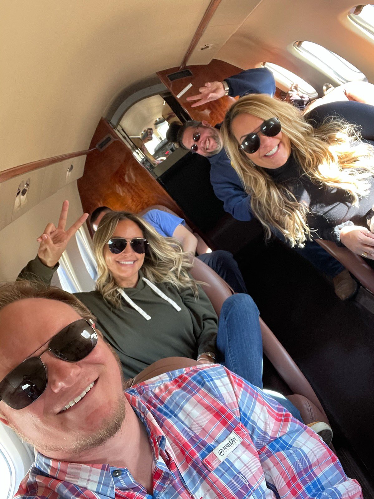 a group of people in sunglasses on a plane