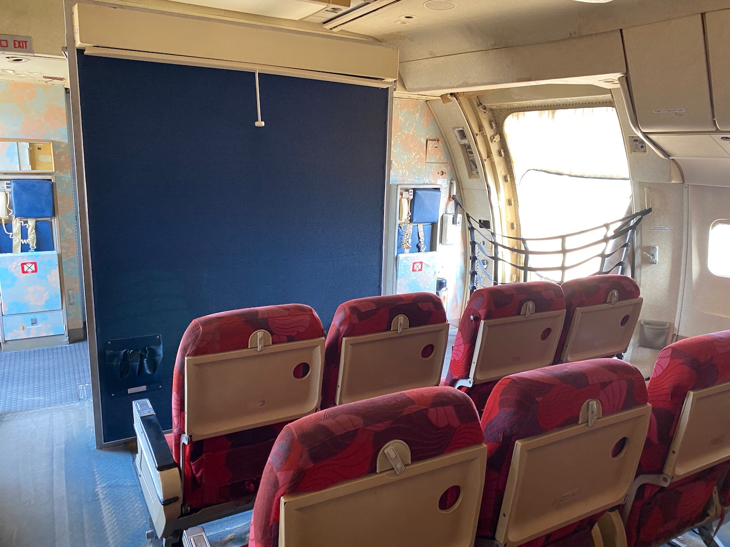 a row of red seats in an airplane