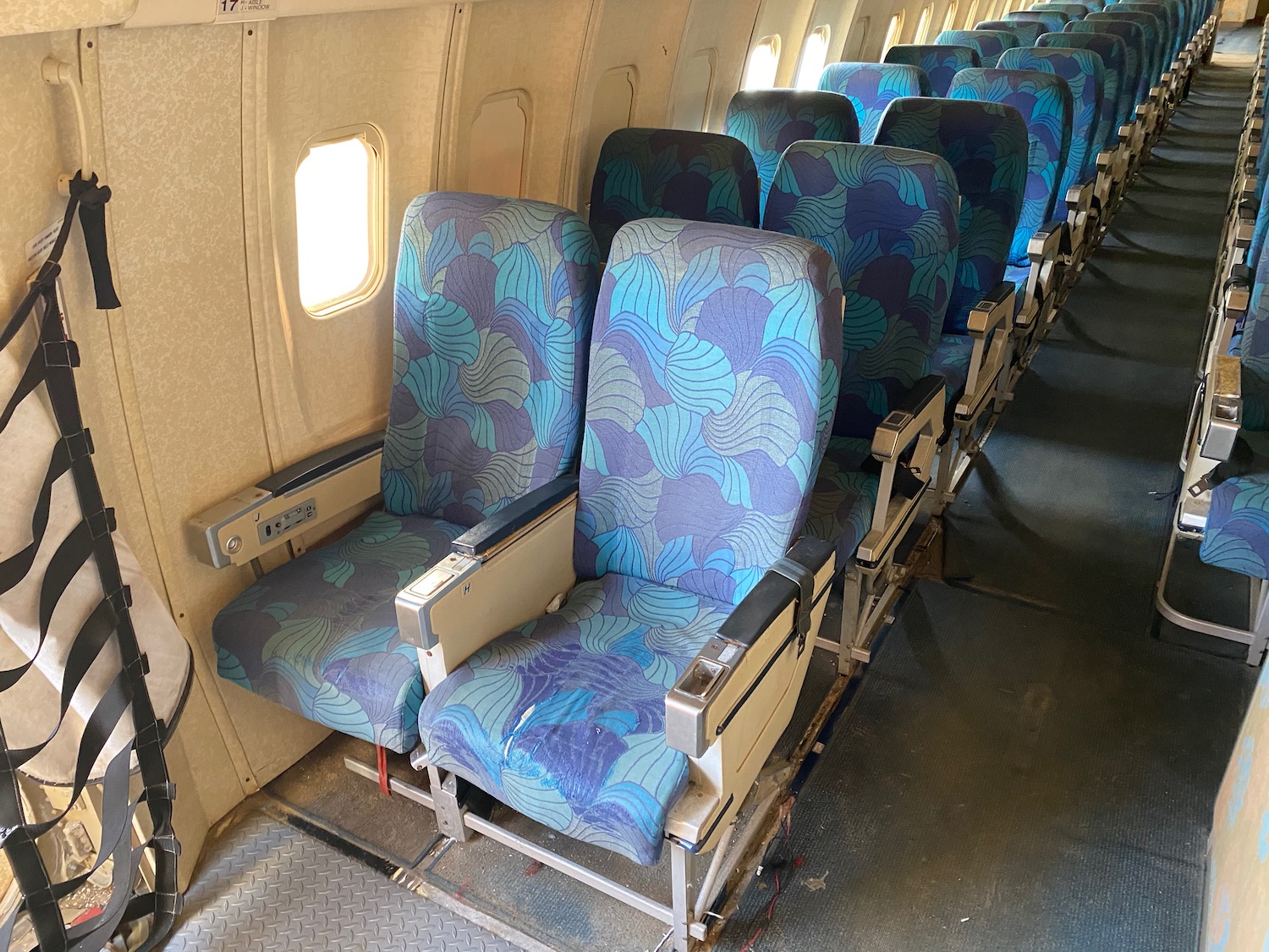 a row of blue chairs in an airplane