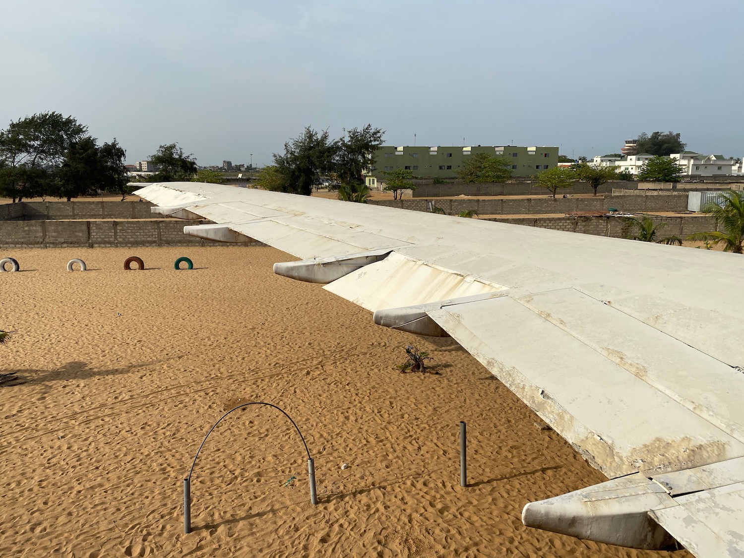 an airplane wing on a sandy area