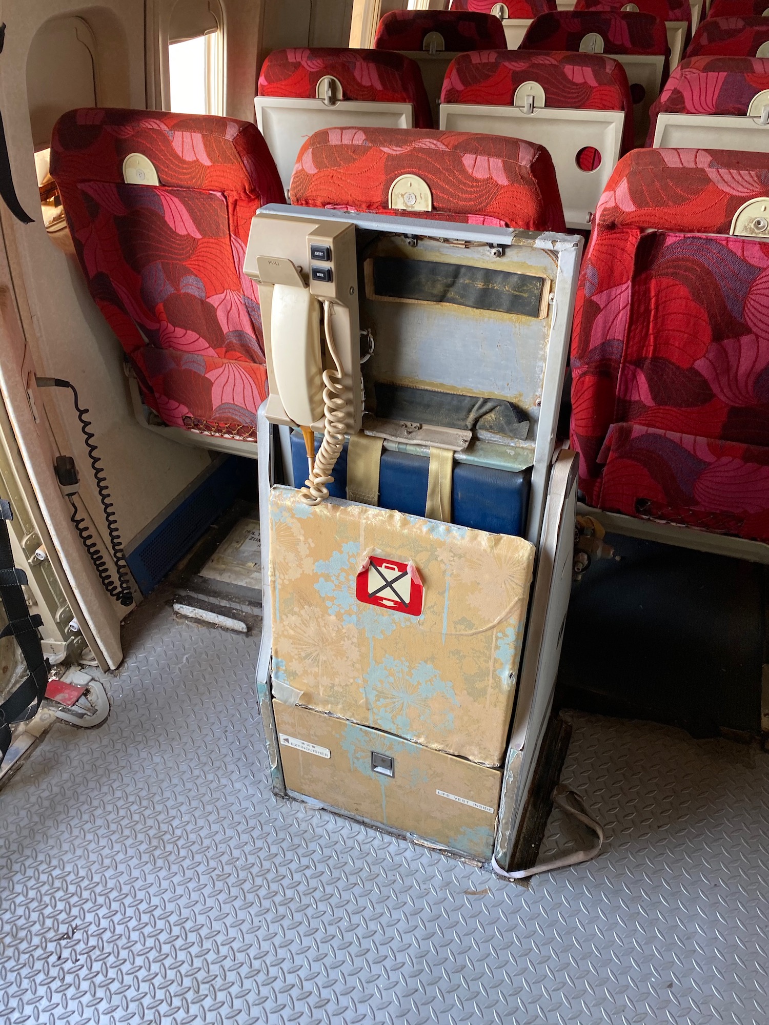 a telephone and boxes in a seat on a plane