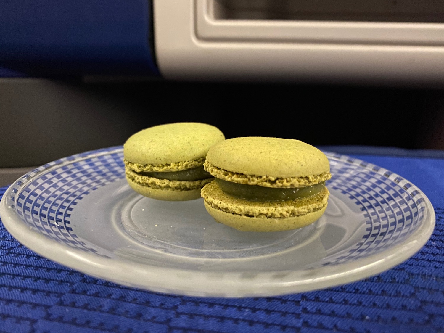 two green cookies on a plate