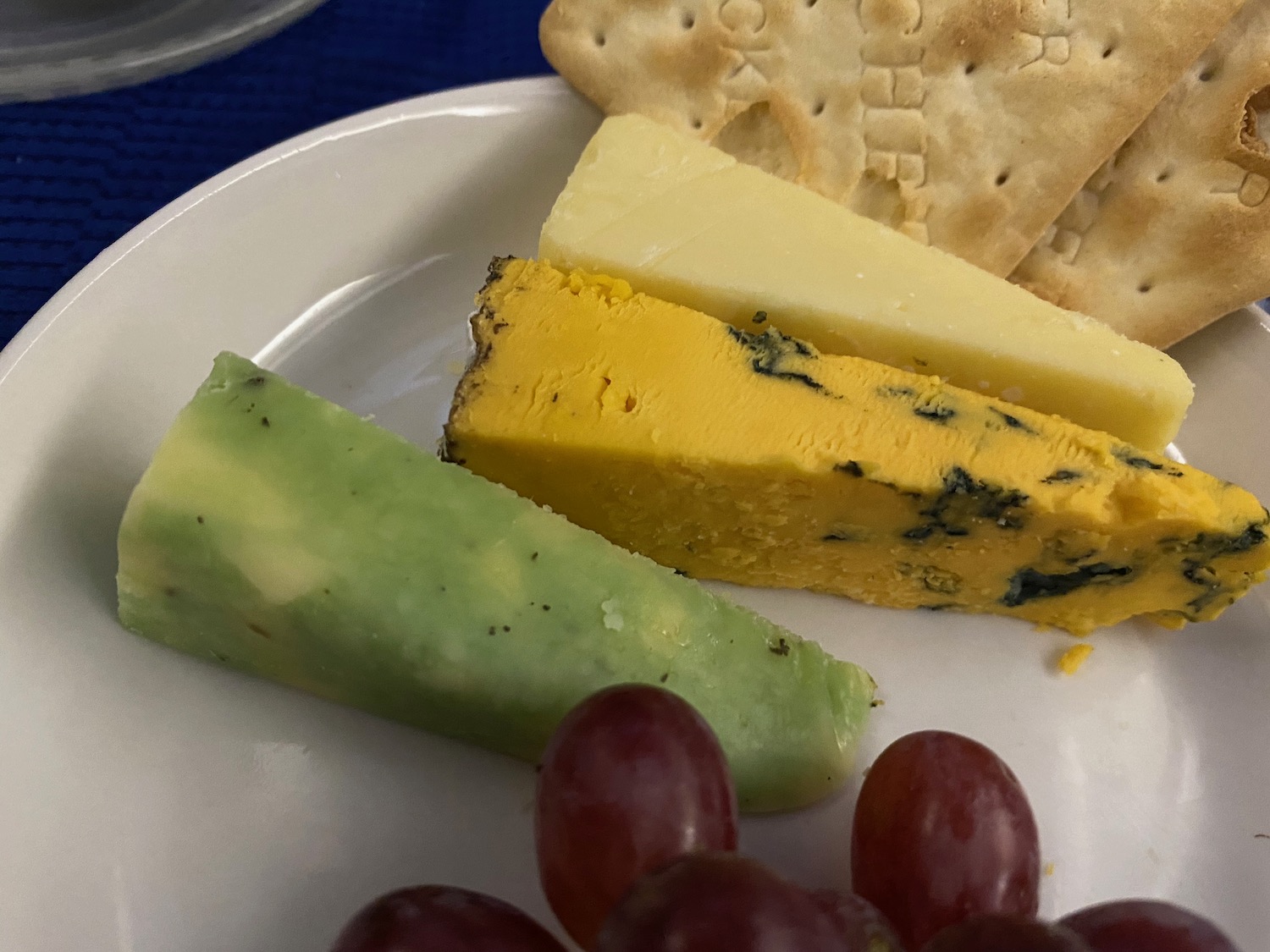 a plate of cheese and grapes