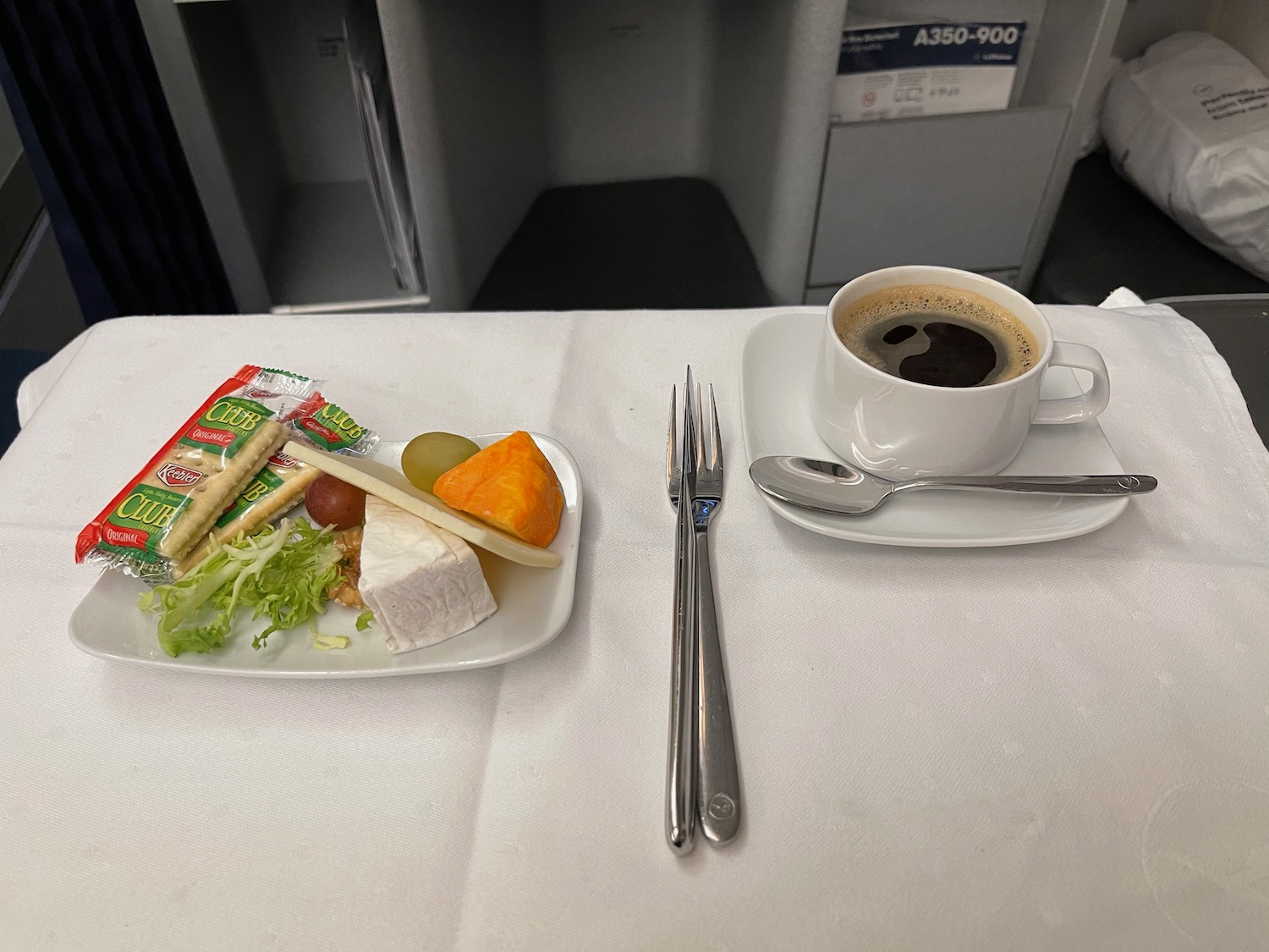 a plate of food and a cup of coffee on a table