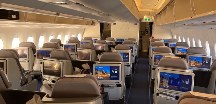 an airplane with rows of seats and monitors