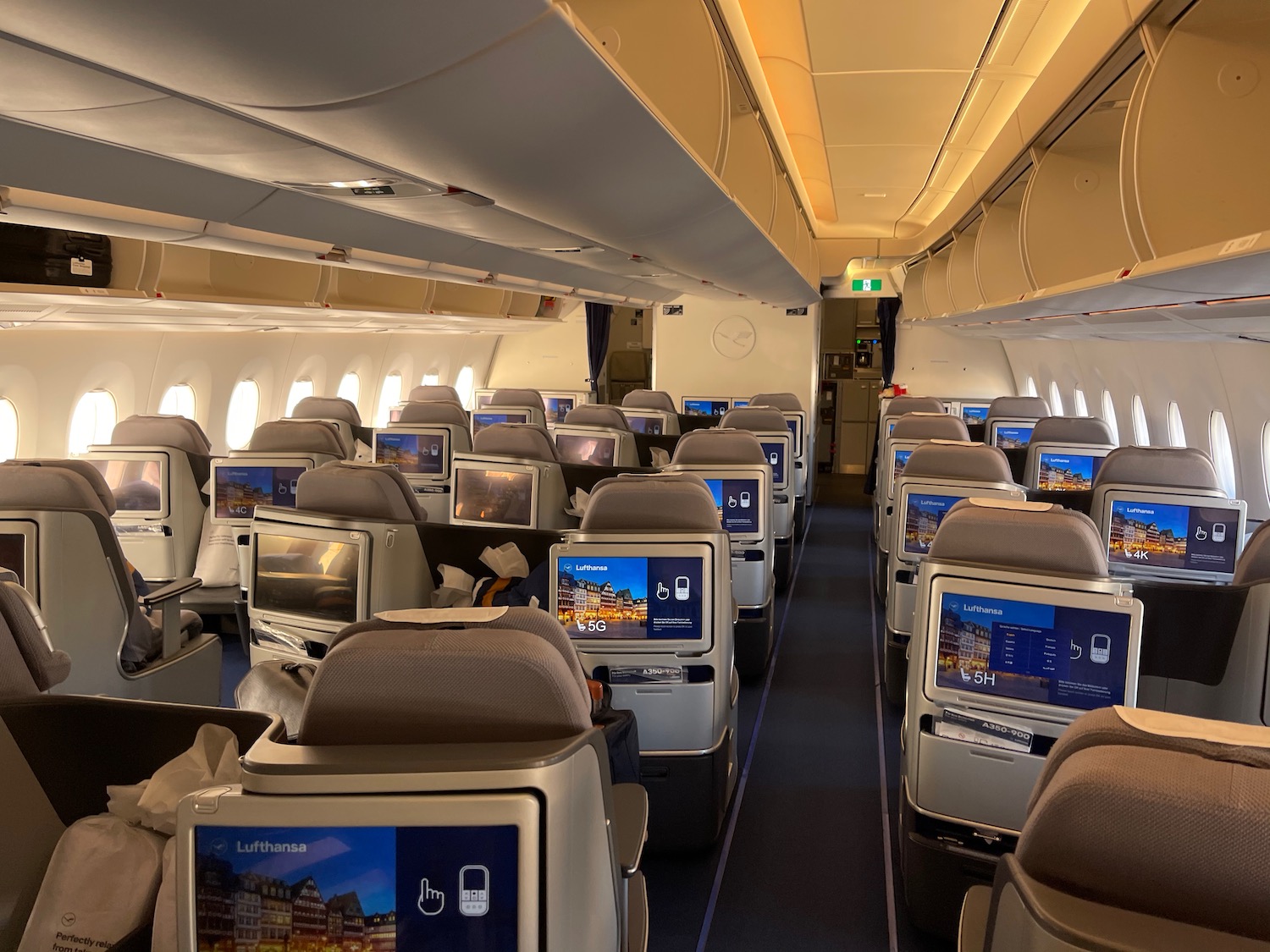 an airplane with rows of seats and monitors