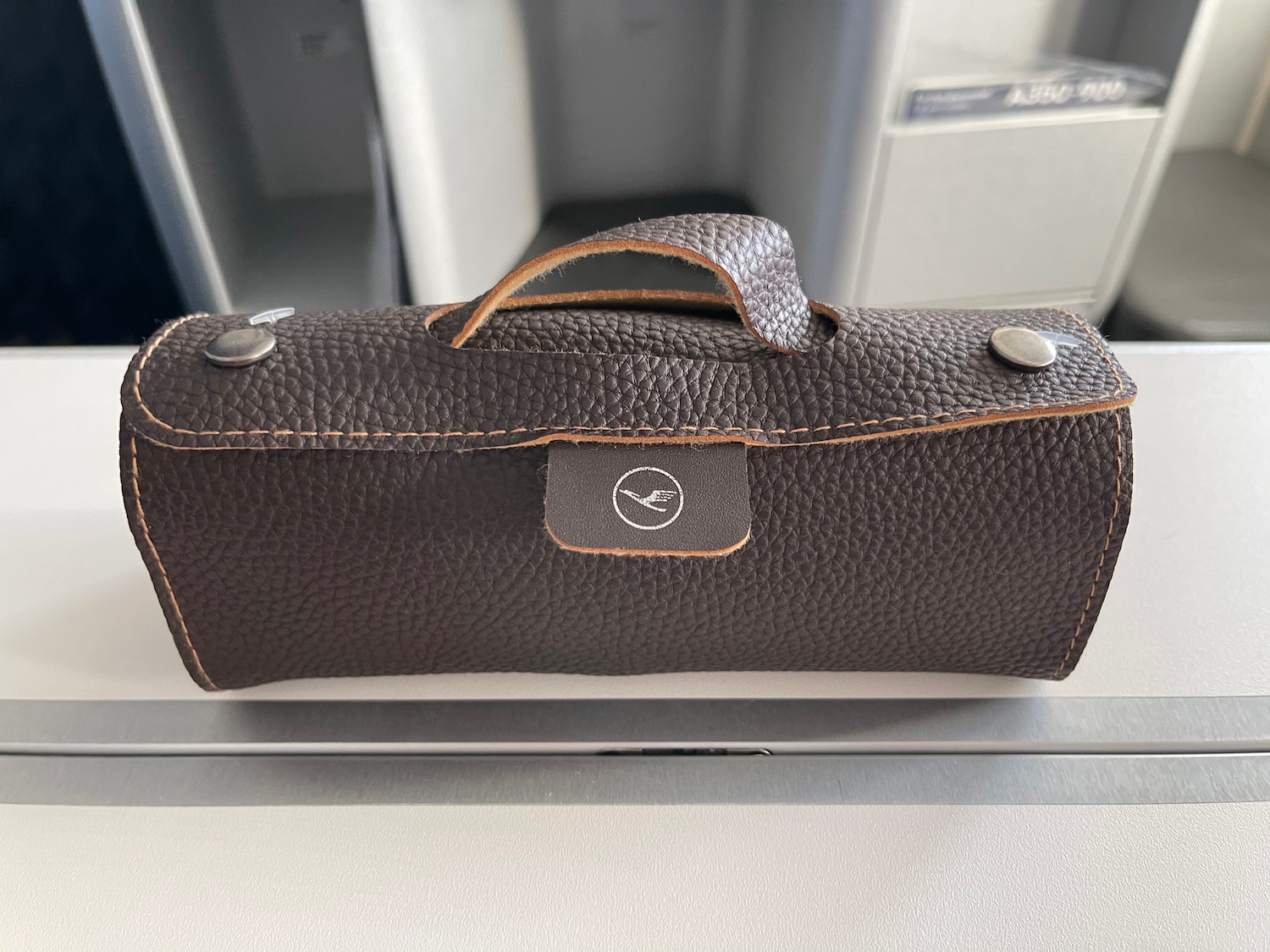 a brown leather case with a handle