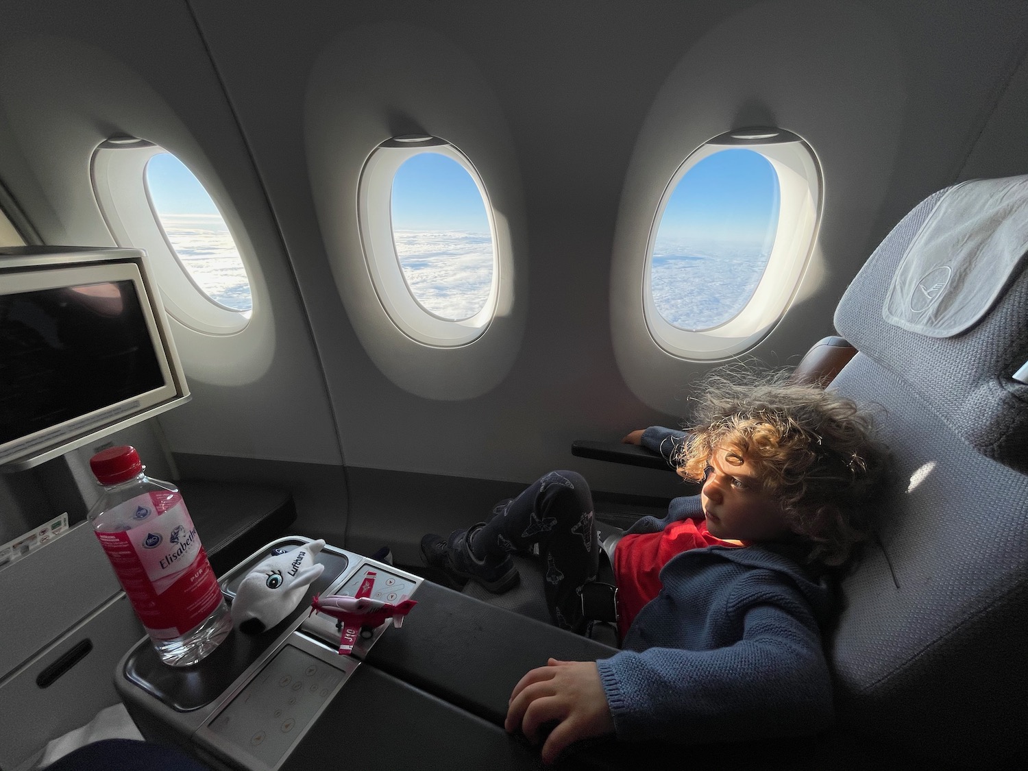 a child sitting in an airplane seat