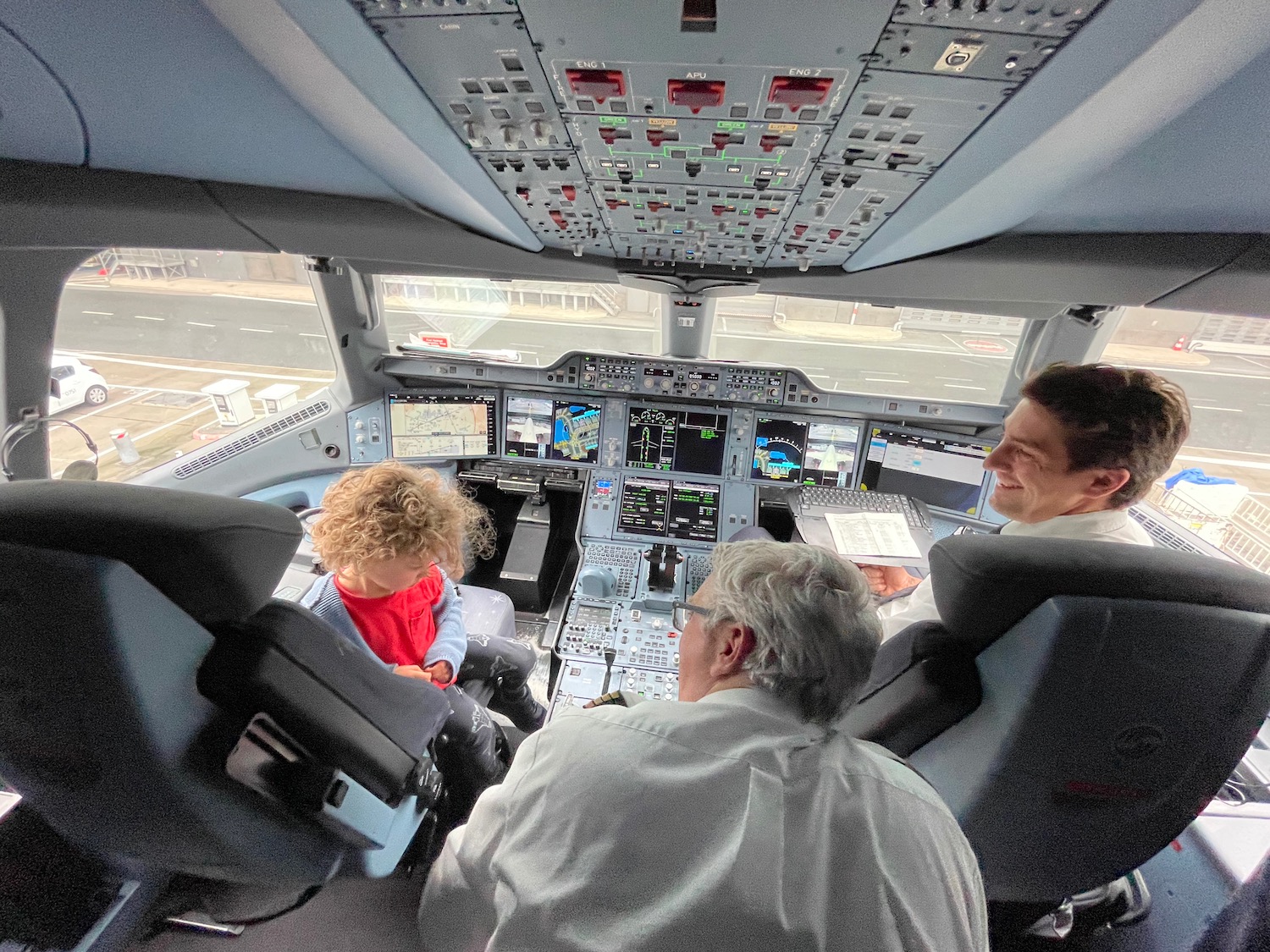 a group of people in a cockpit of an airplane