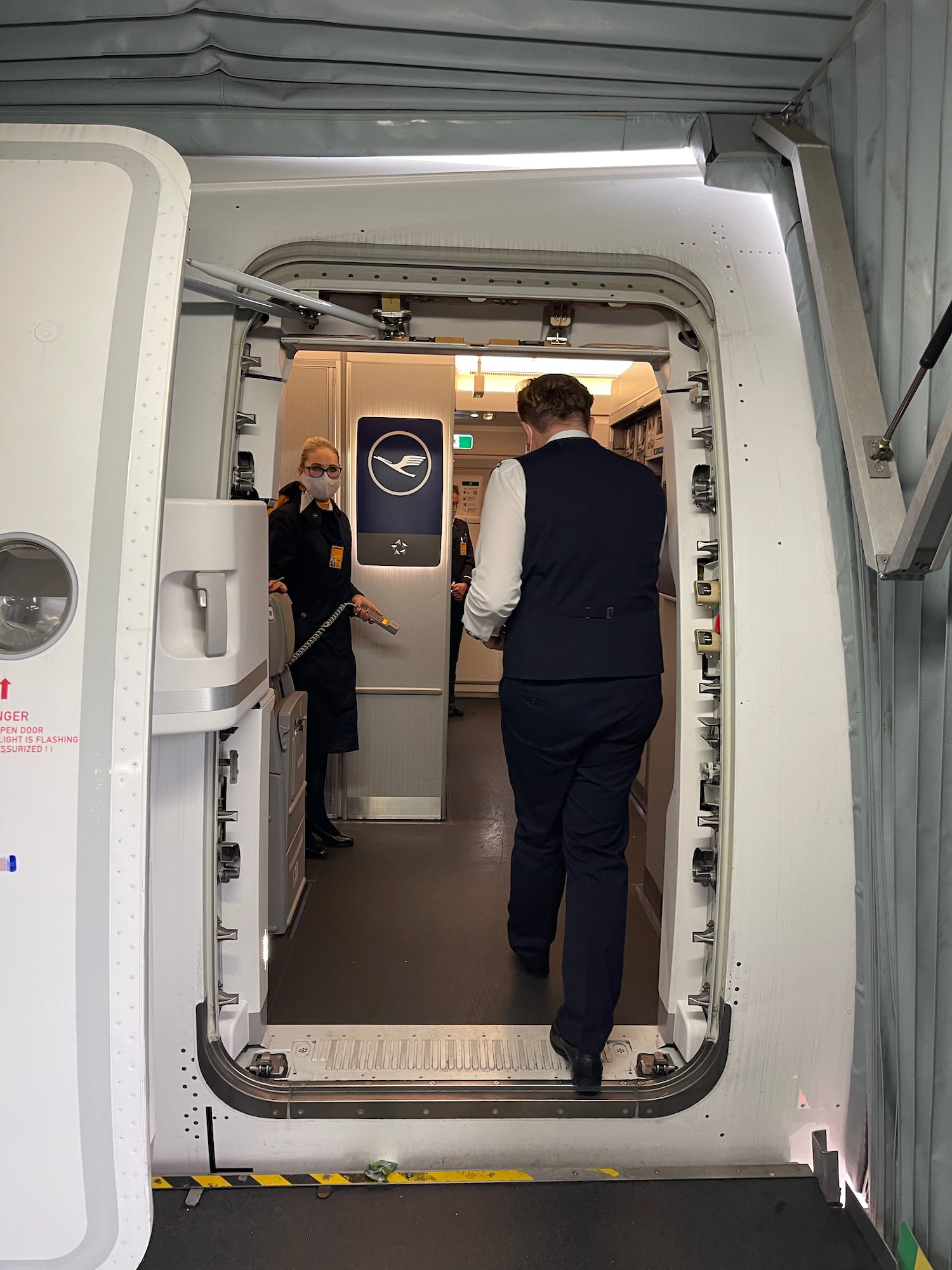 a man in a suit walking into an airplane