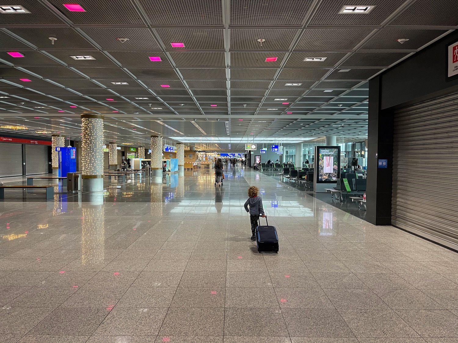 a child with a suitcase in a large airport