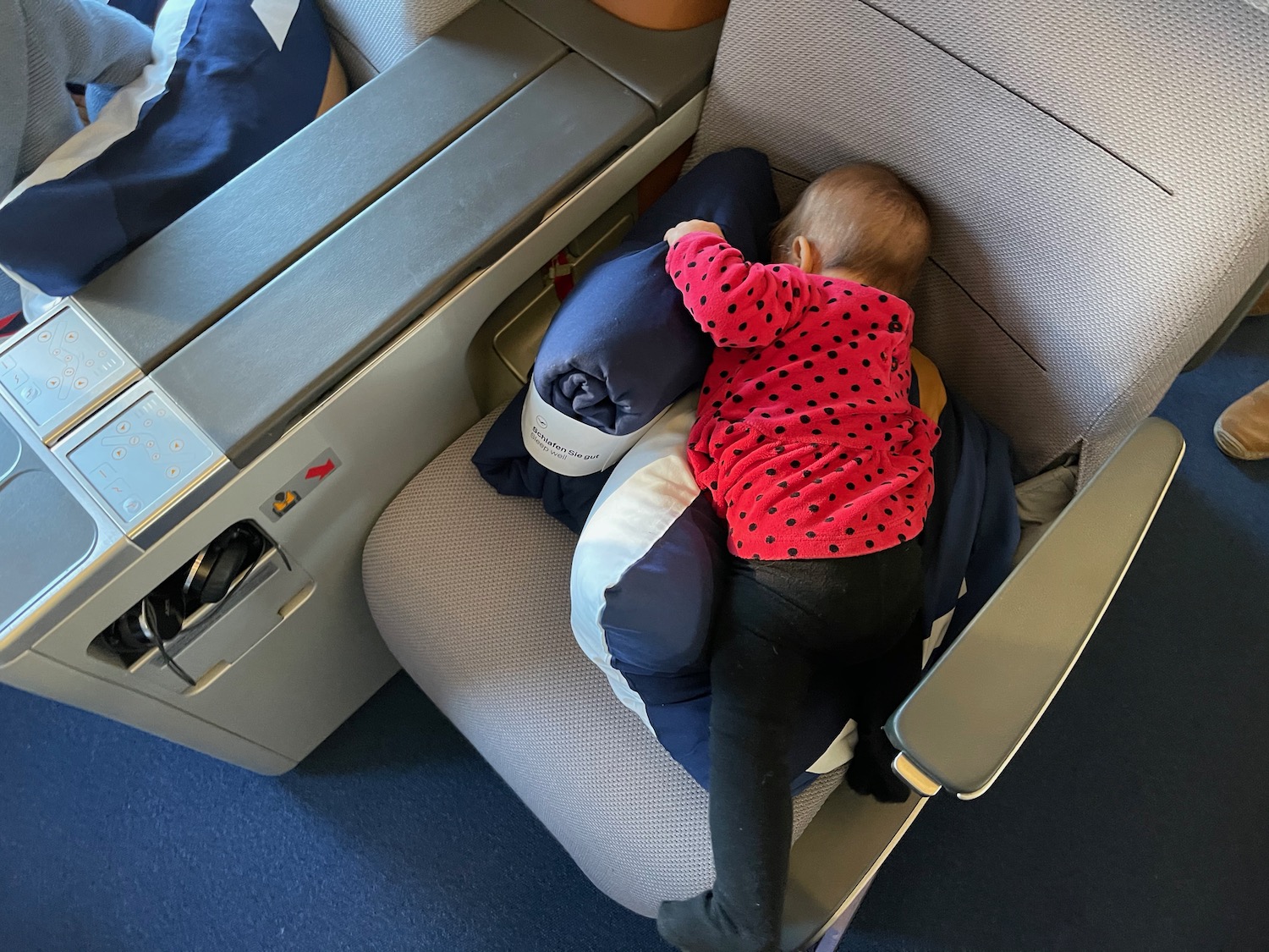 a baby sleeping on a chair