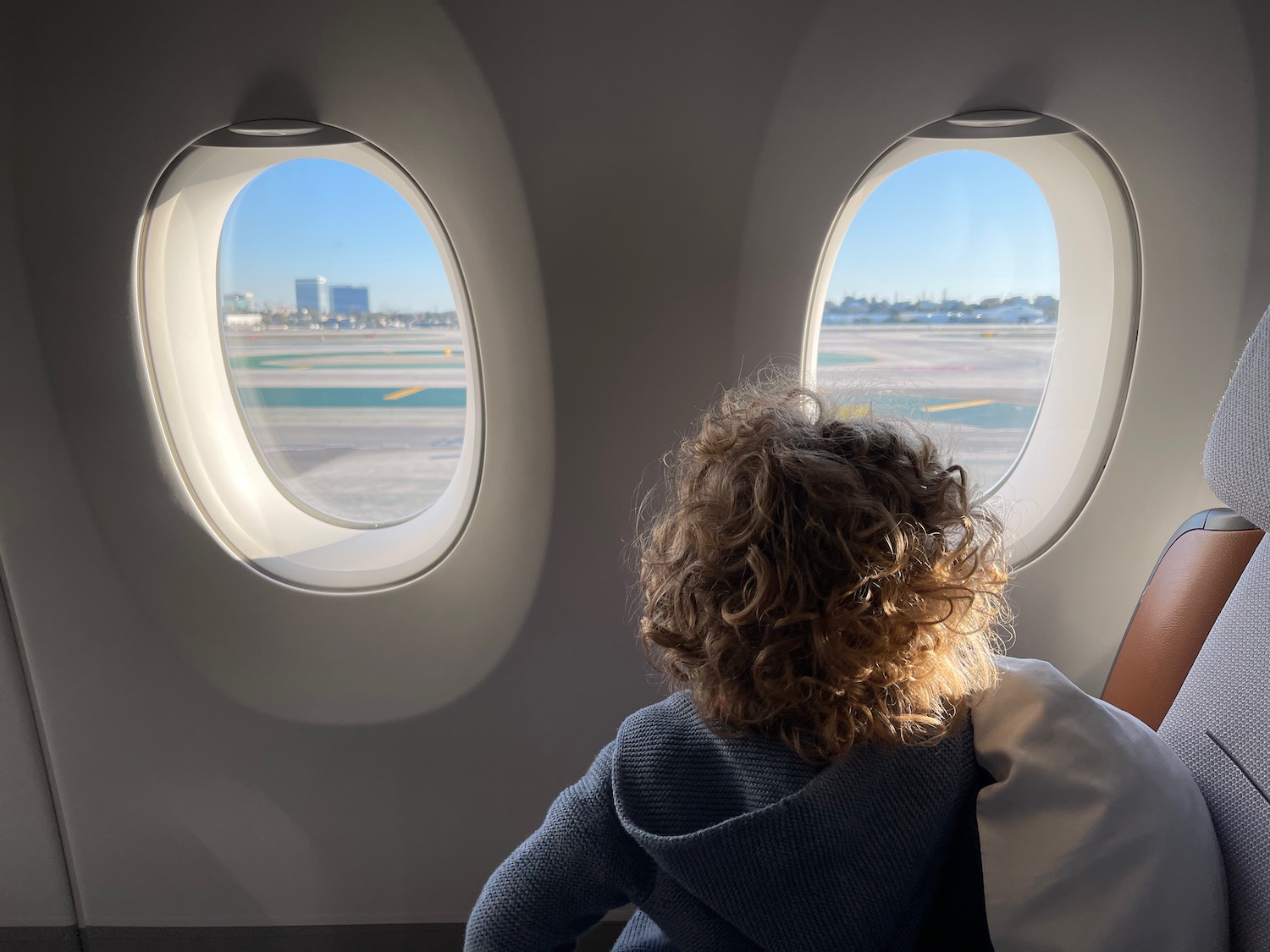 a child looking out of an airplane window