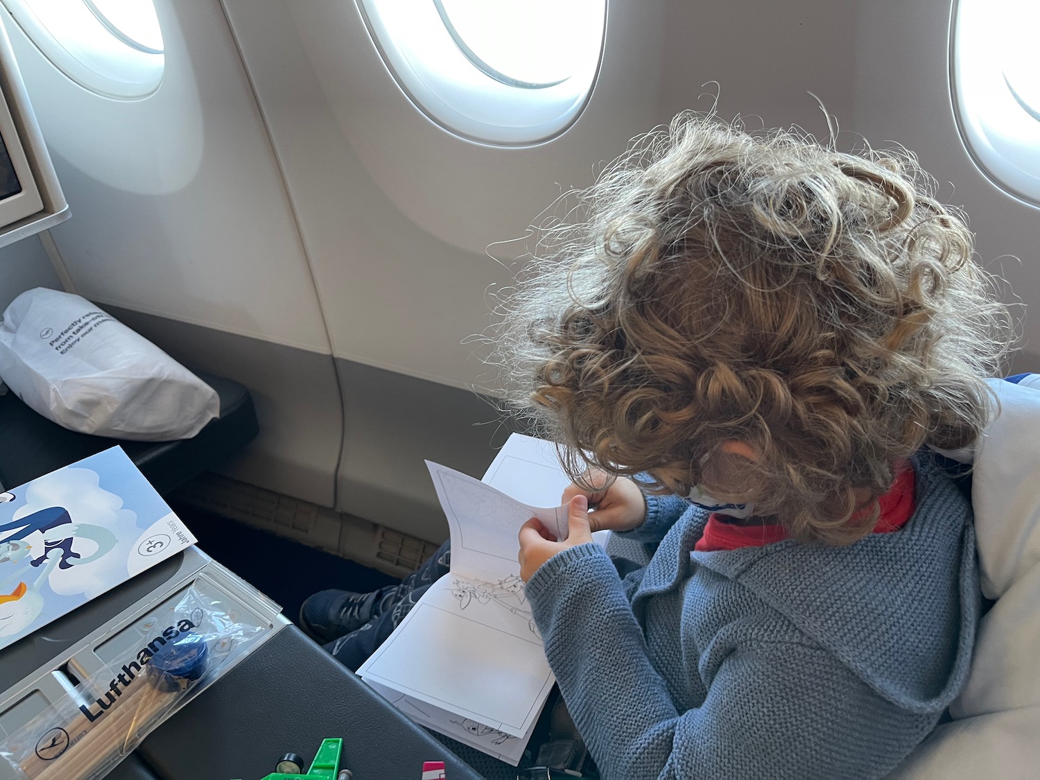 a child sitting at a table with a piece of paper