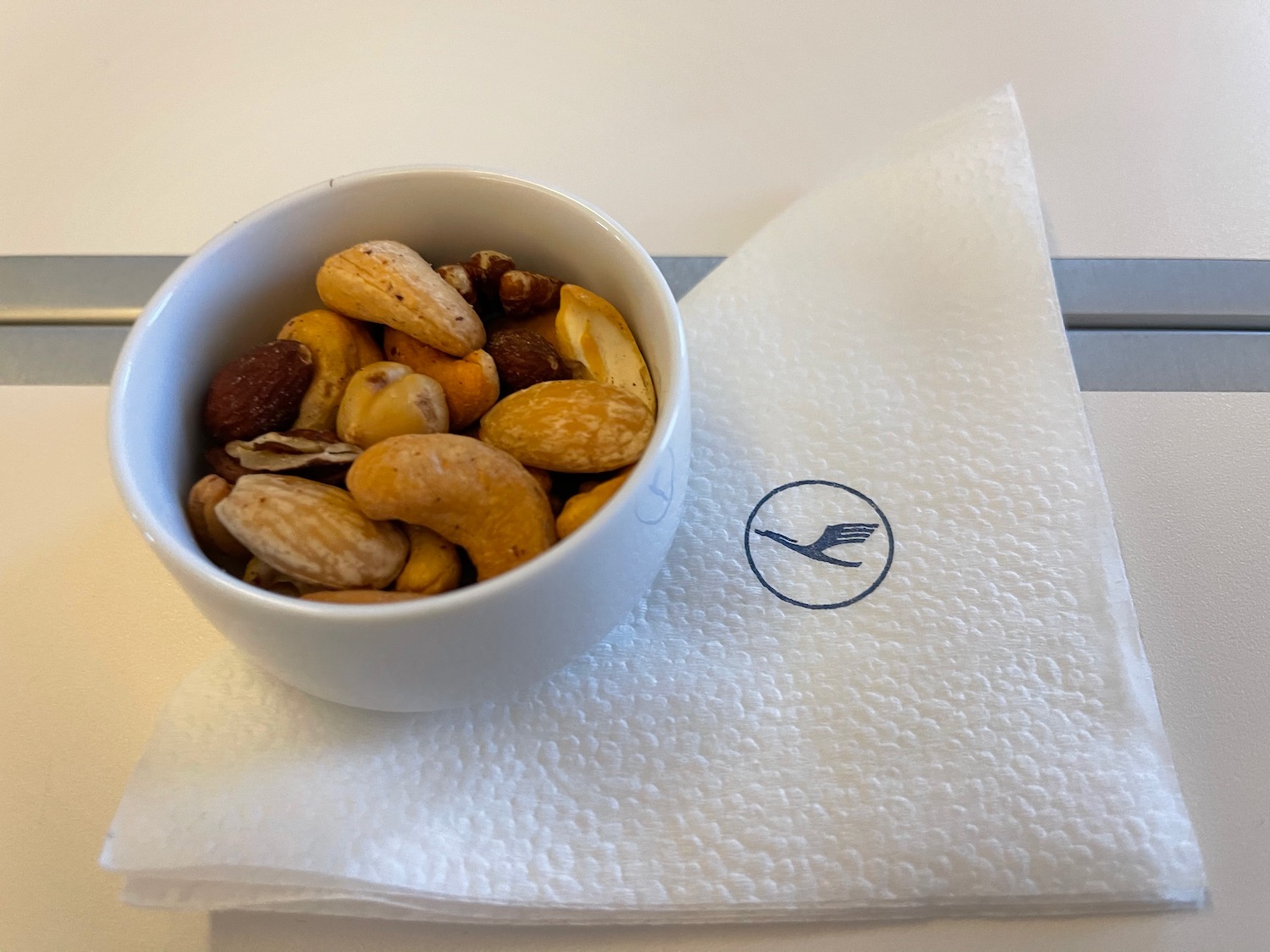 a bowl of nuts on a napkin