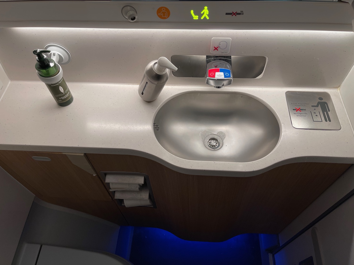 a sink and soap dispenser on a plane