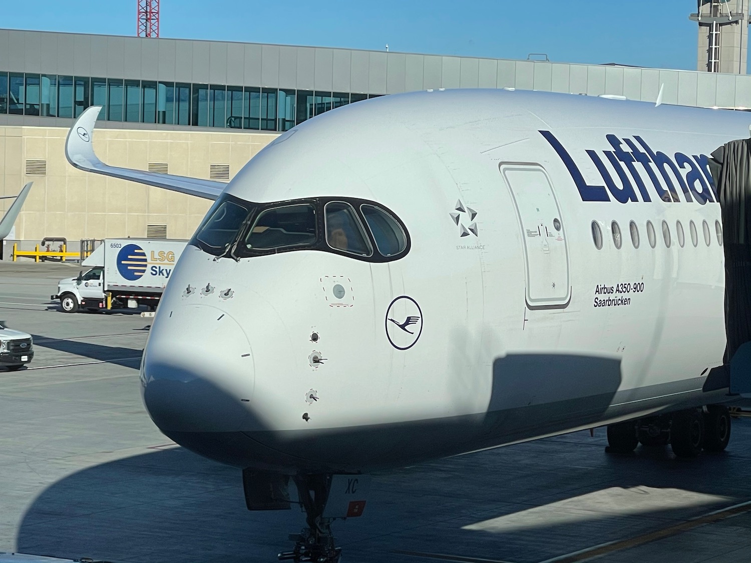 a white airplane with blue writing on it