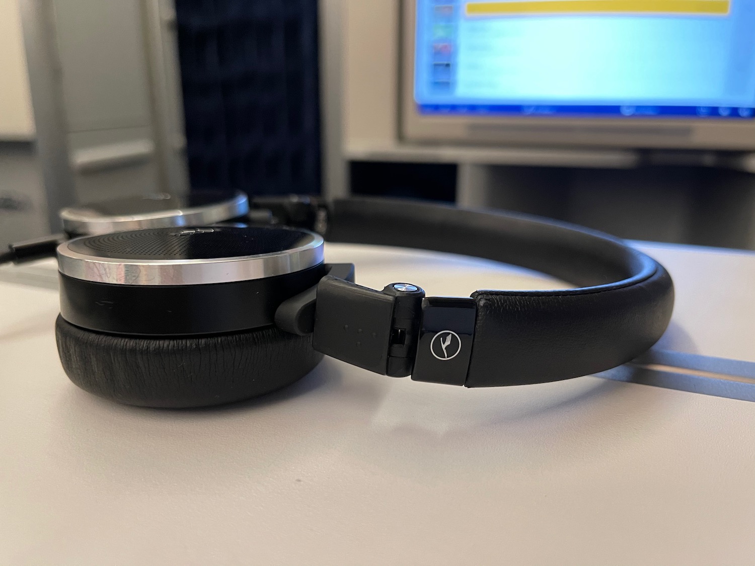 a black headphones on a white surface