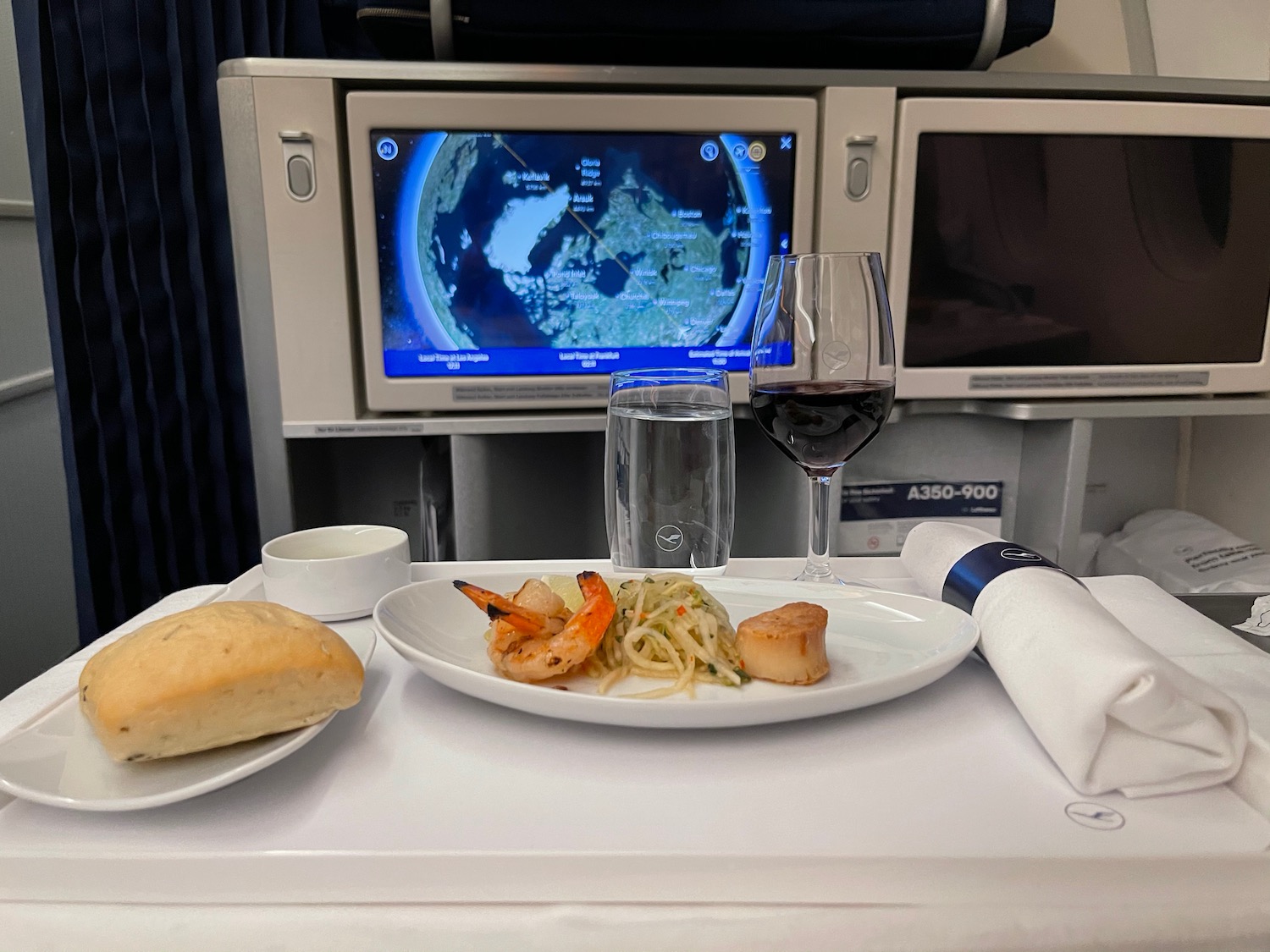 a plate of food on a table with a television in the background