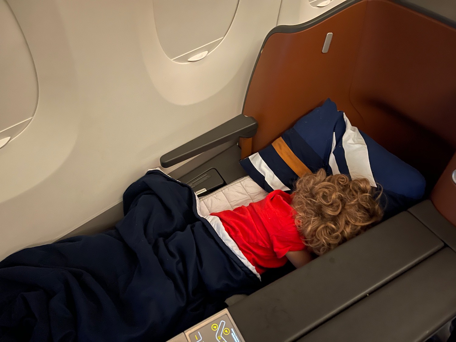 a child sleeping on a plane