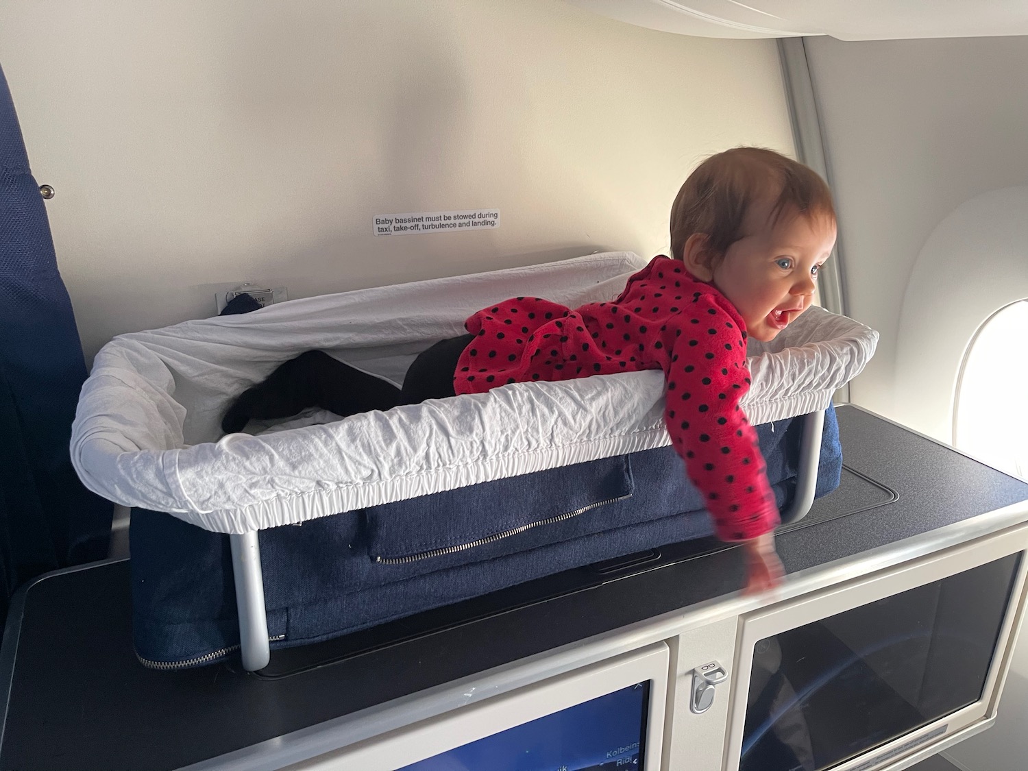 a baby lying on a baby bed