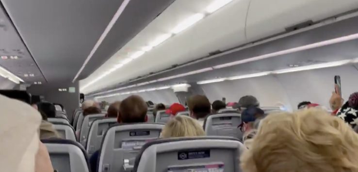 a group of people sitting in an airplane