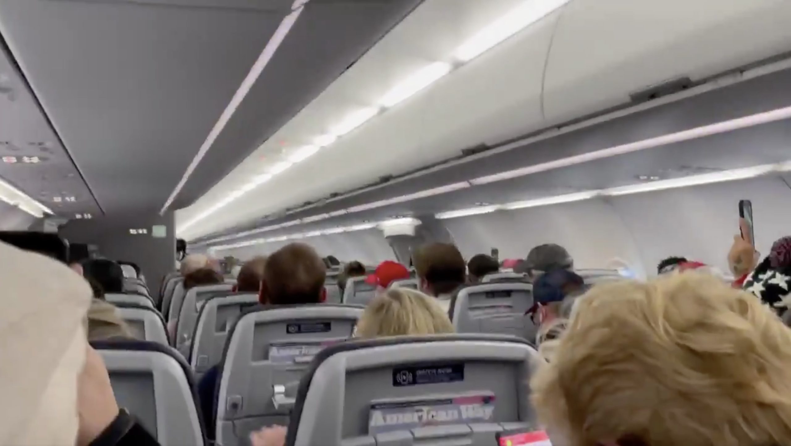 a group of people sitting in an airplane