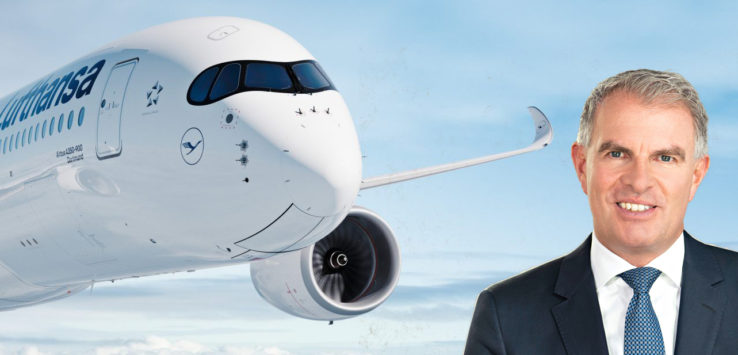 a man in a suit standing in front of a plane