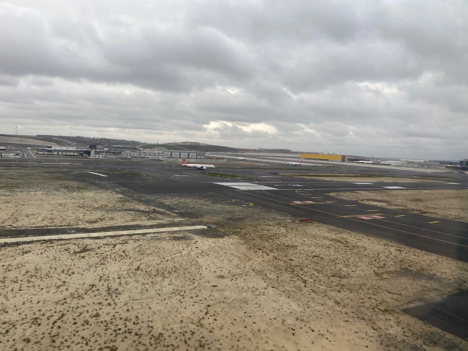 an airport runway with planes on it