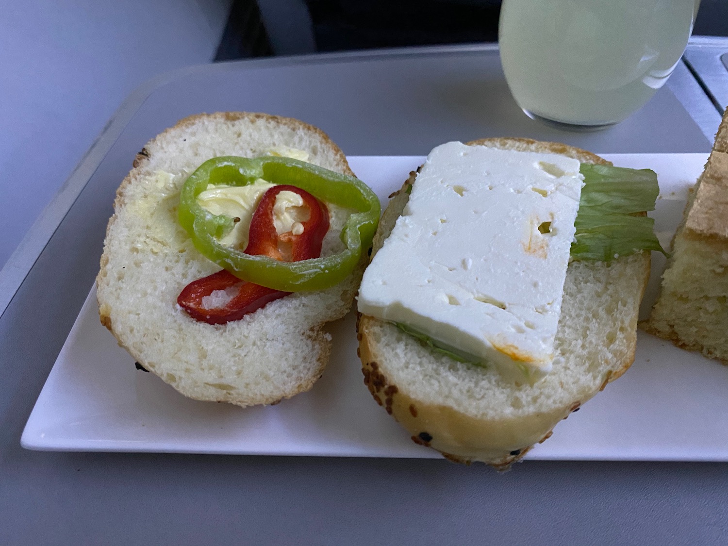 a sandwich with cheese and peppers on a plate