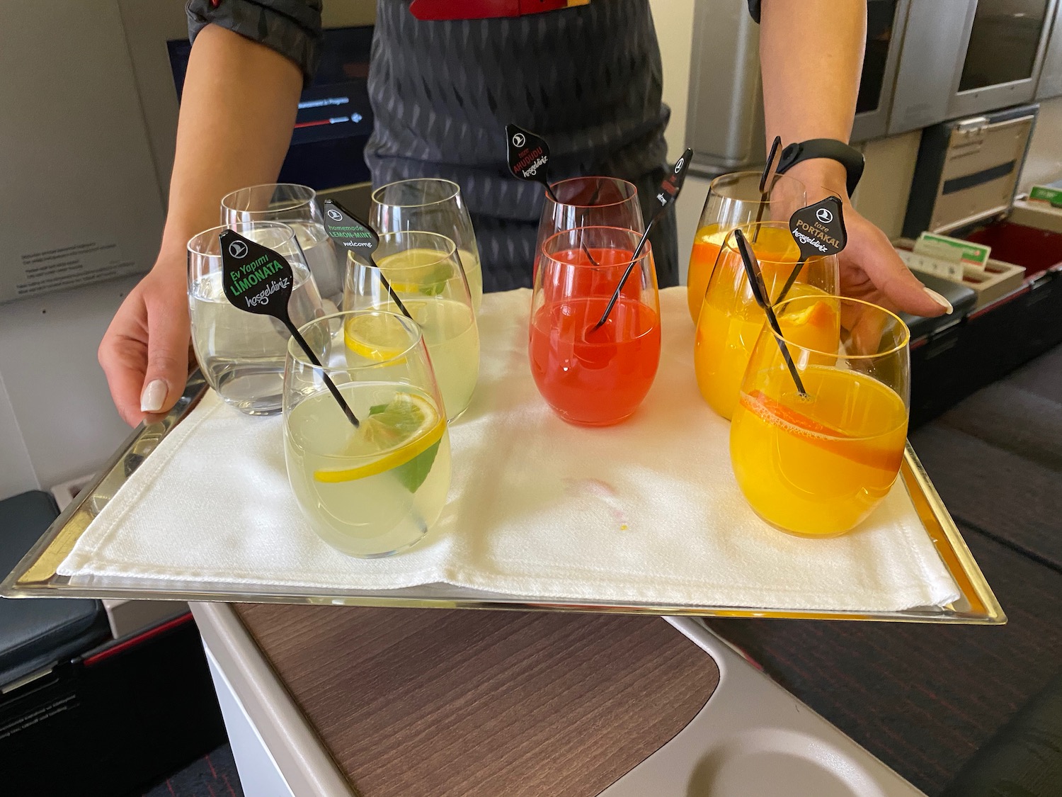 a tray of drinks with different colored drinks