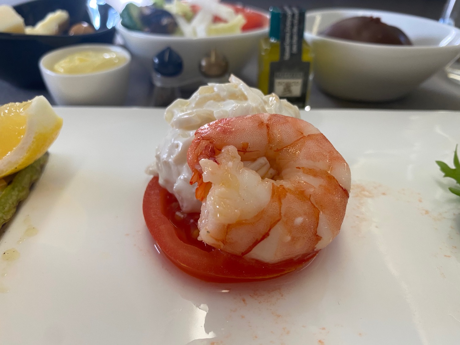 a shrimp on a tomato on a plate