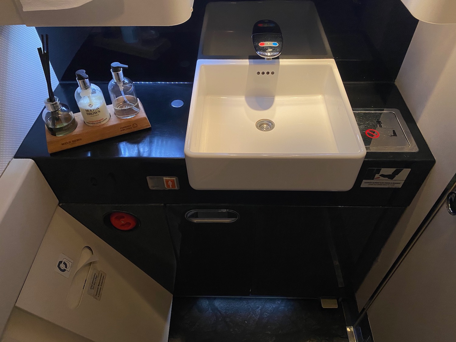 a sink and soap dispenser on a counter