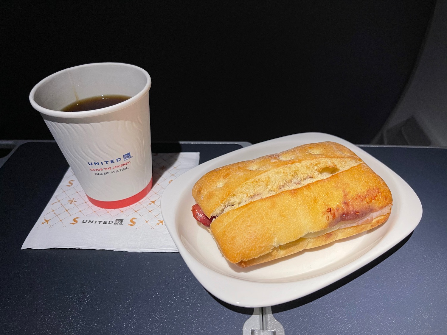 a hot dog and a cup of coffee