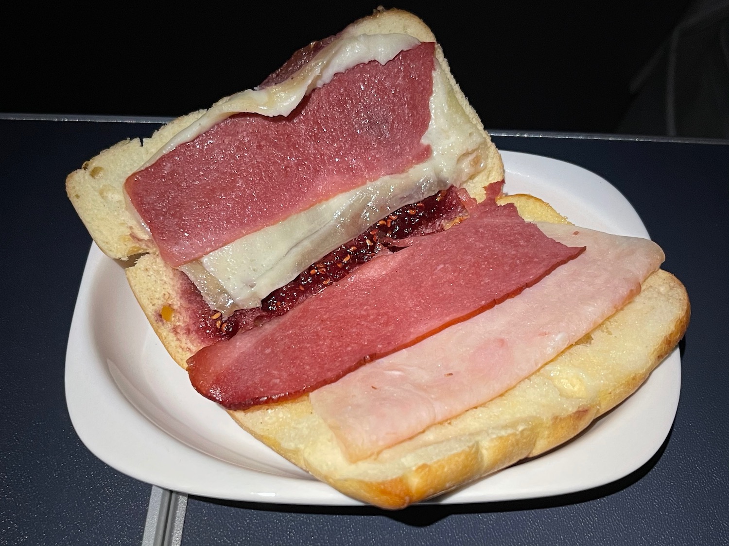 a sandwich with meat and cheese on a plate