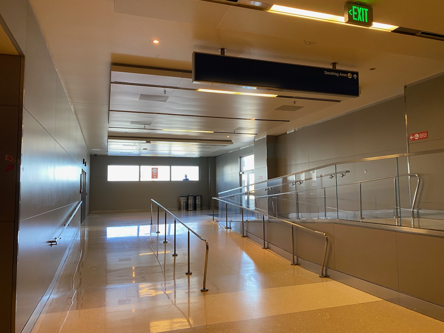 a hallway with railings and a sign