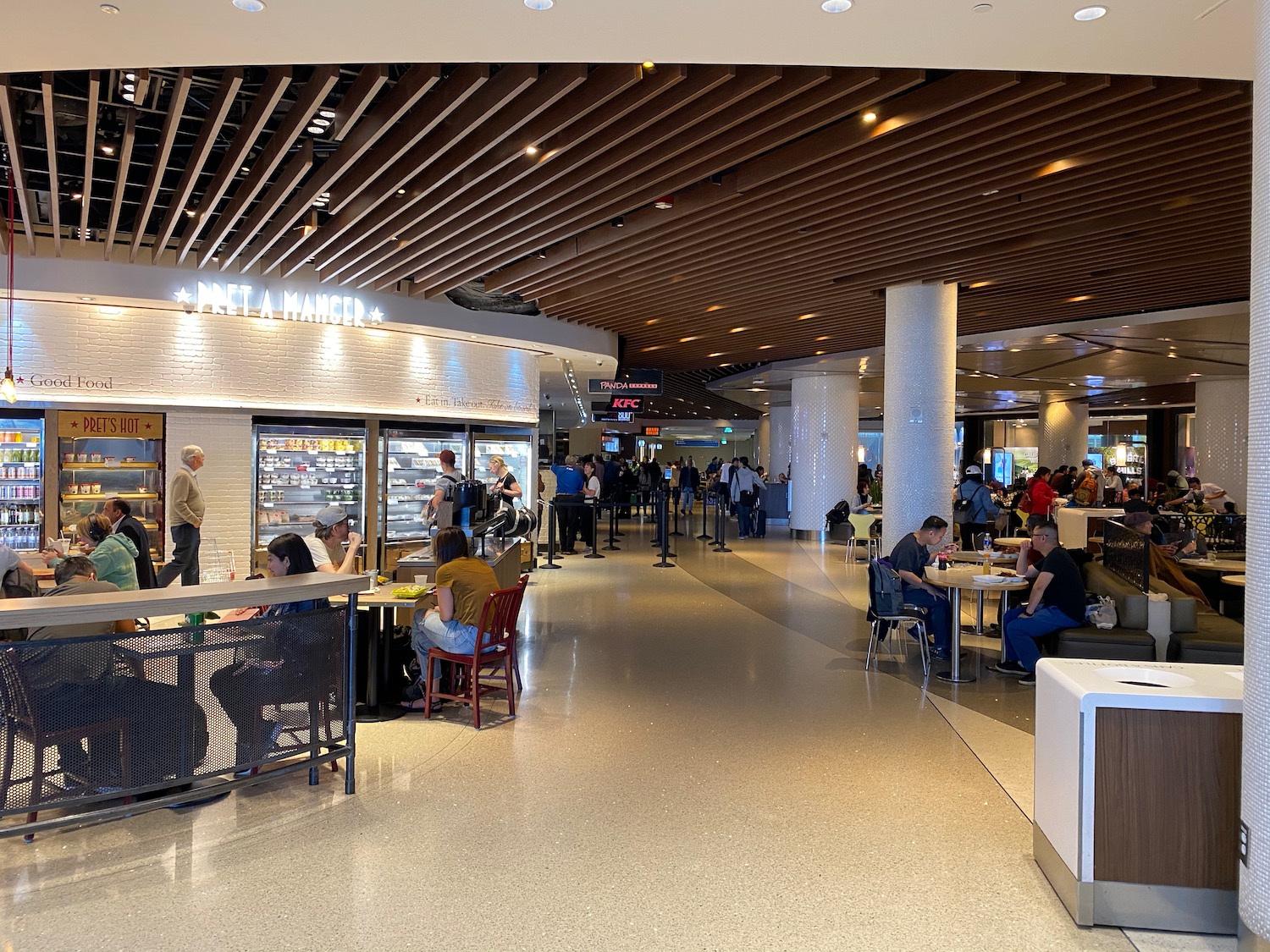 people sitting at tables in a large building