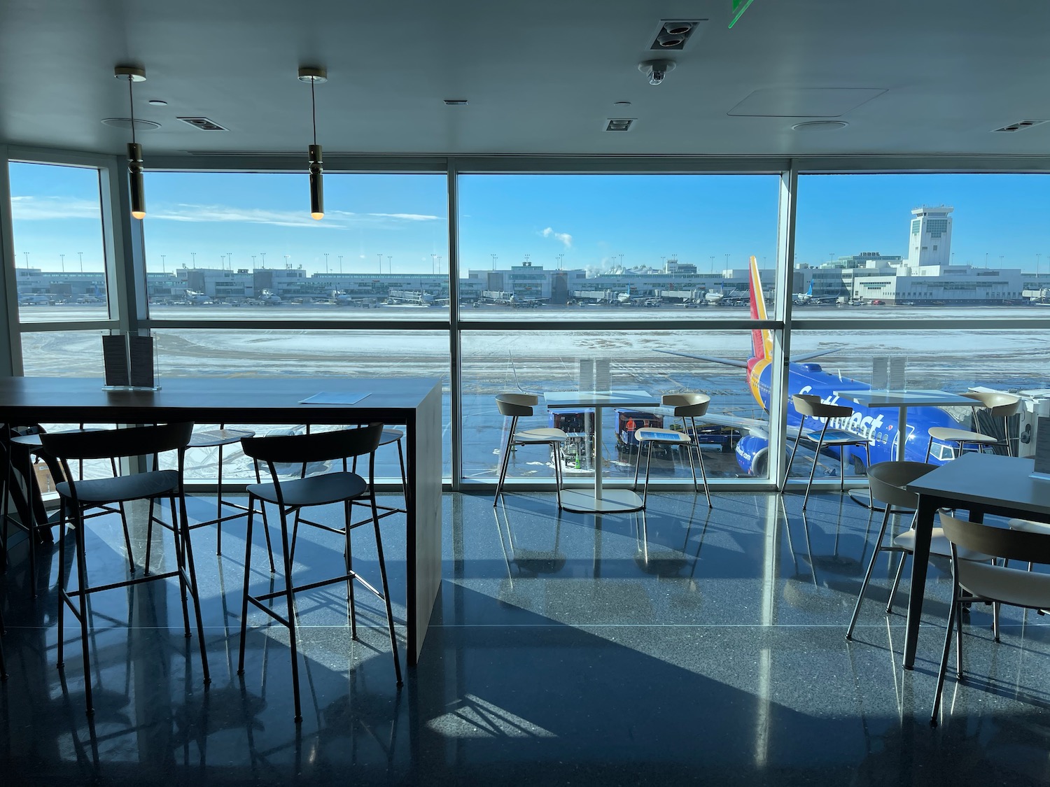 a room with a table and chairs and a view of the water