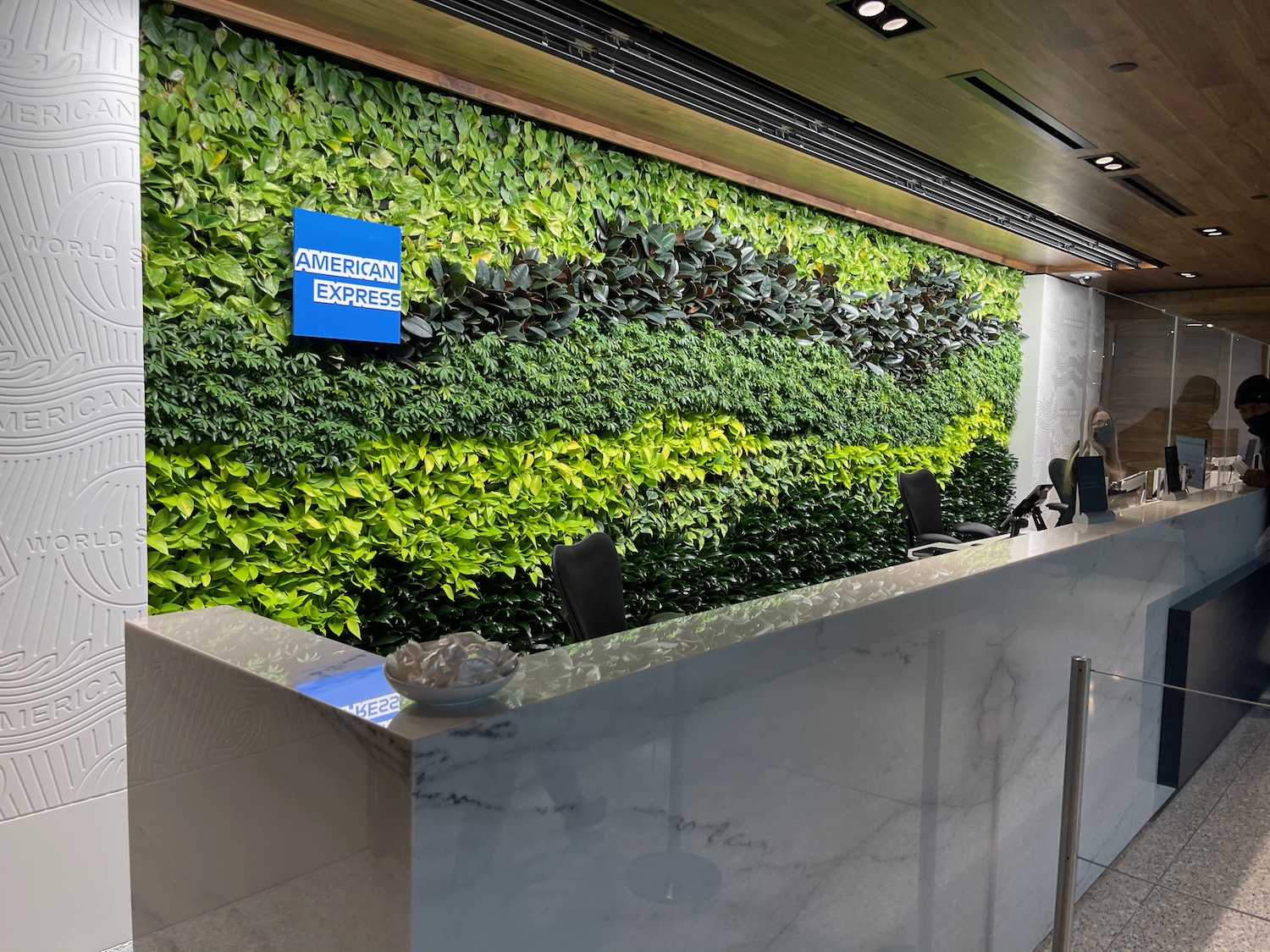 a green wall behind a reception desk