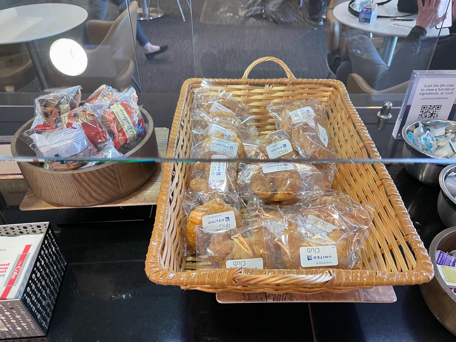 a basket of pastries in plastic bags