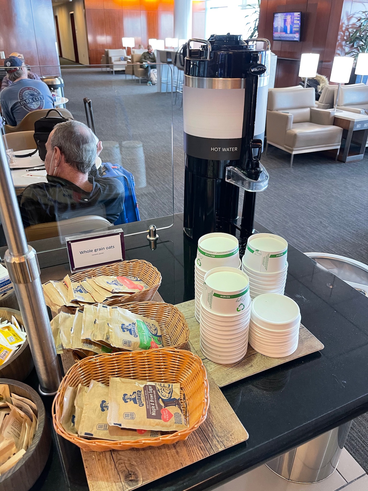 a group of white cups and a black machine