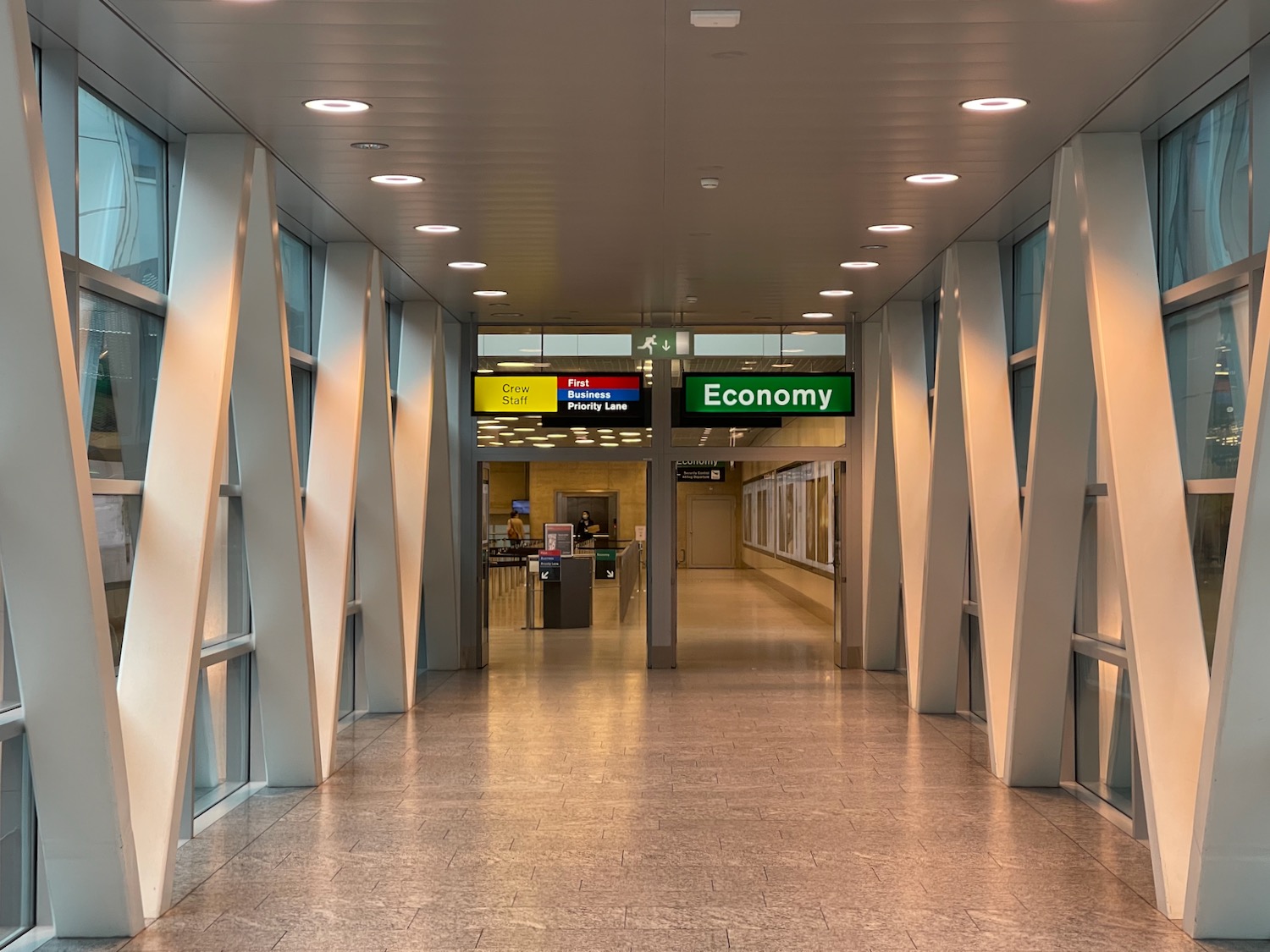 a hallway with signs and a sign on the ceiling