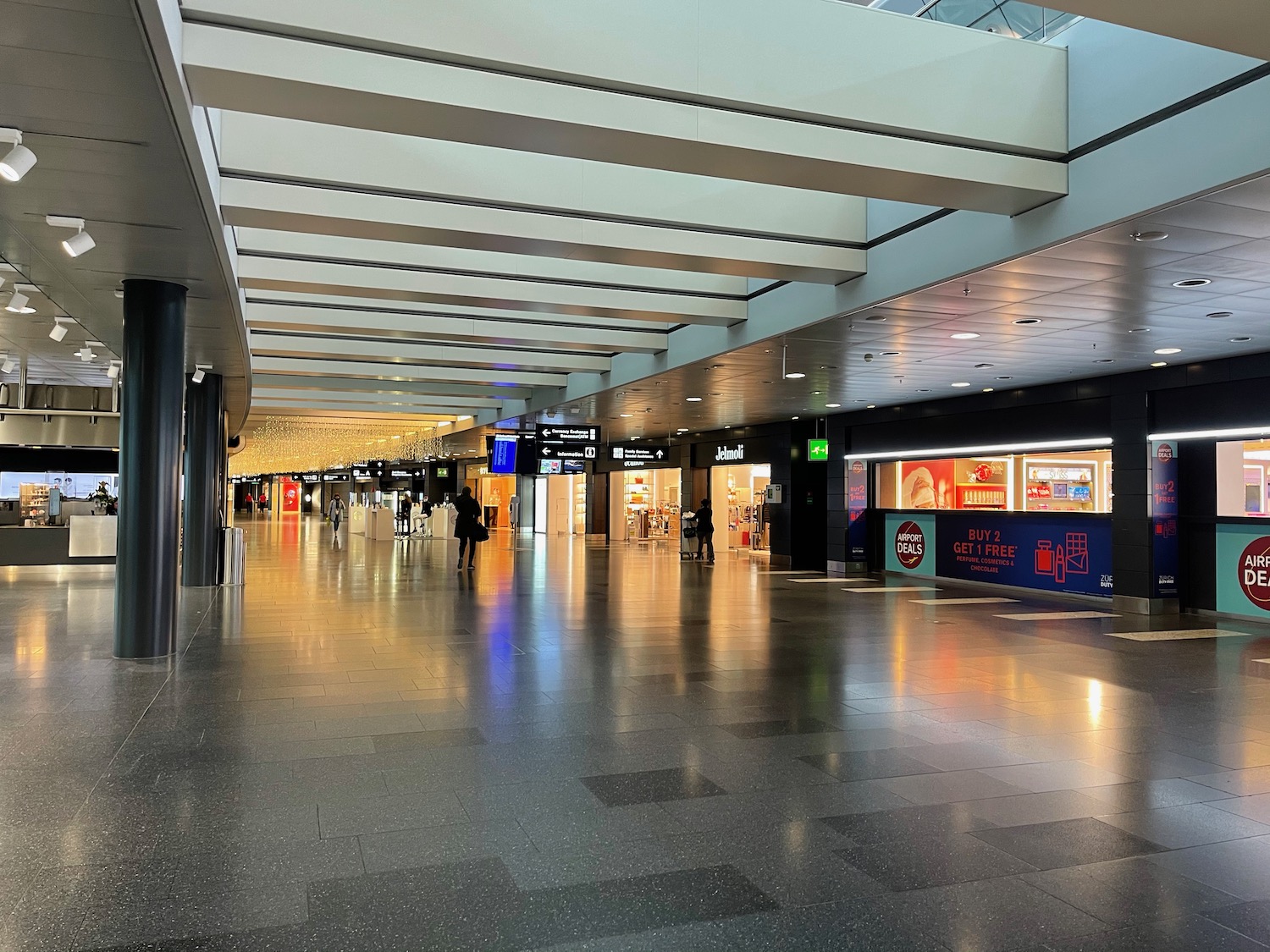 a large airport terminal with people walking