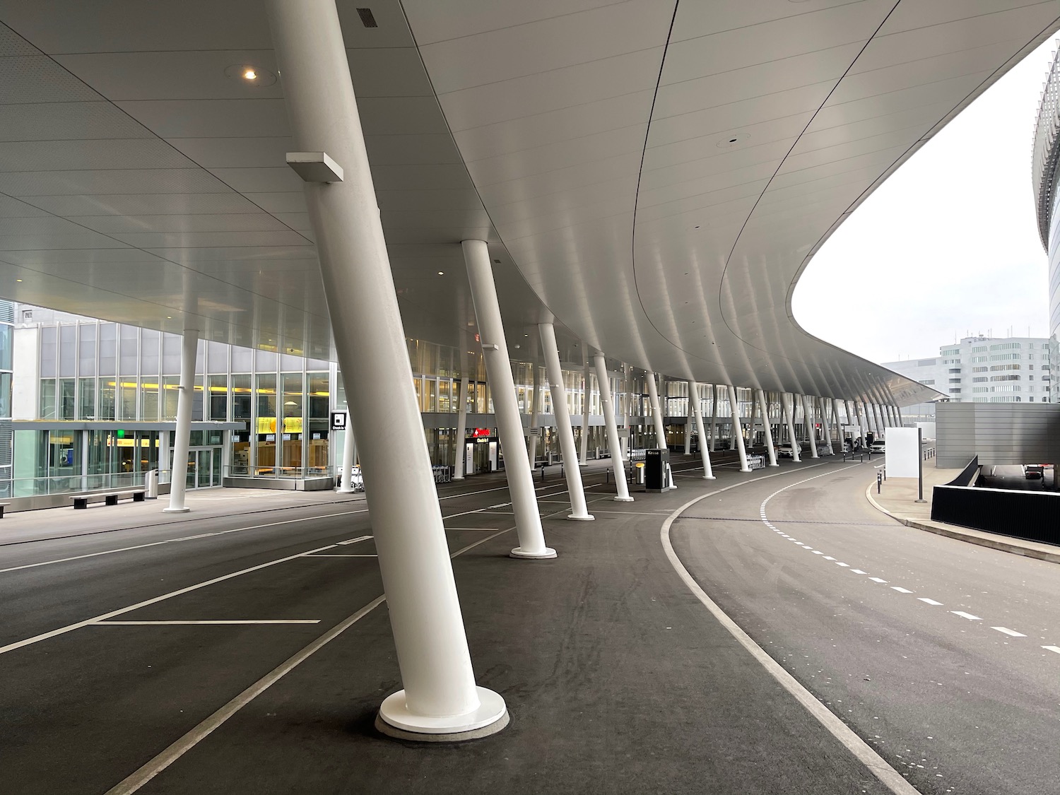 a curved white building with white pillars