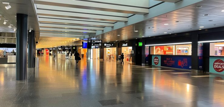 a large airport terminal with people walking