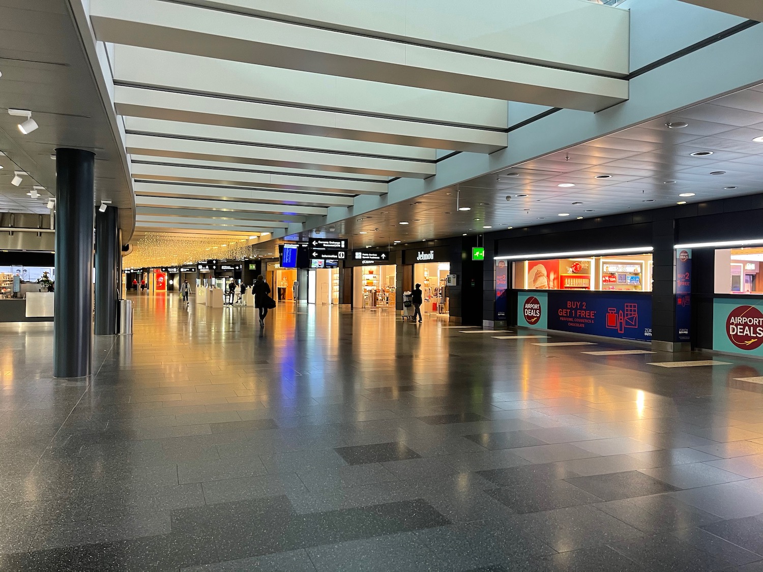 a large airport terminal with people walking