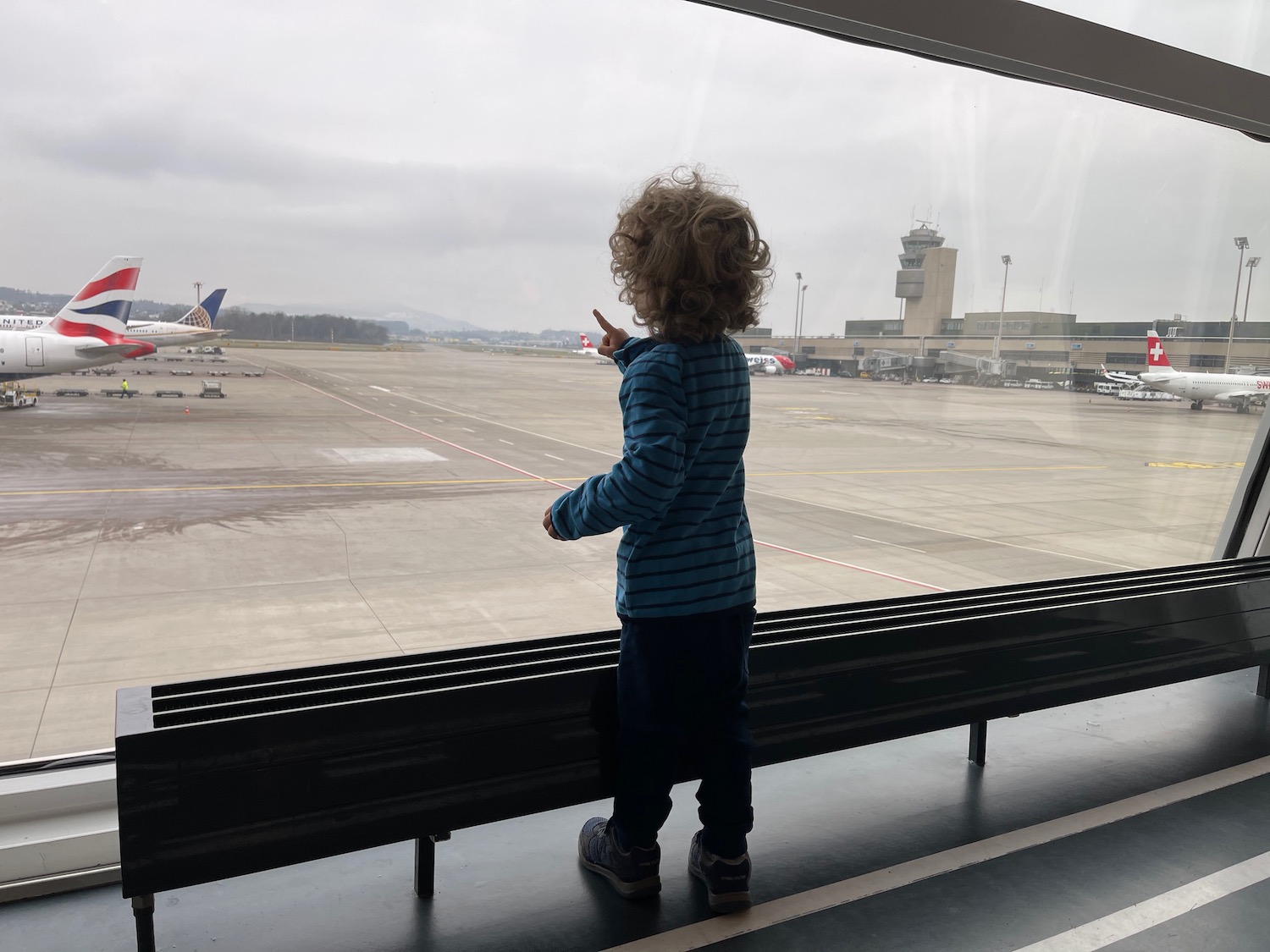 a child standing in front of a window