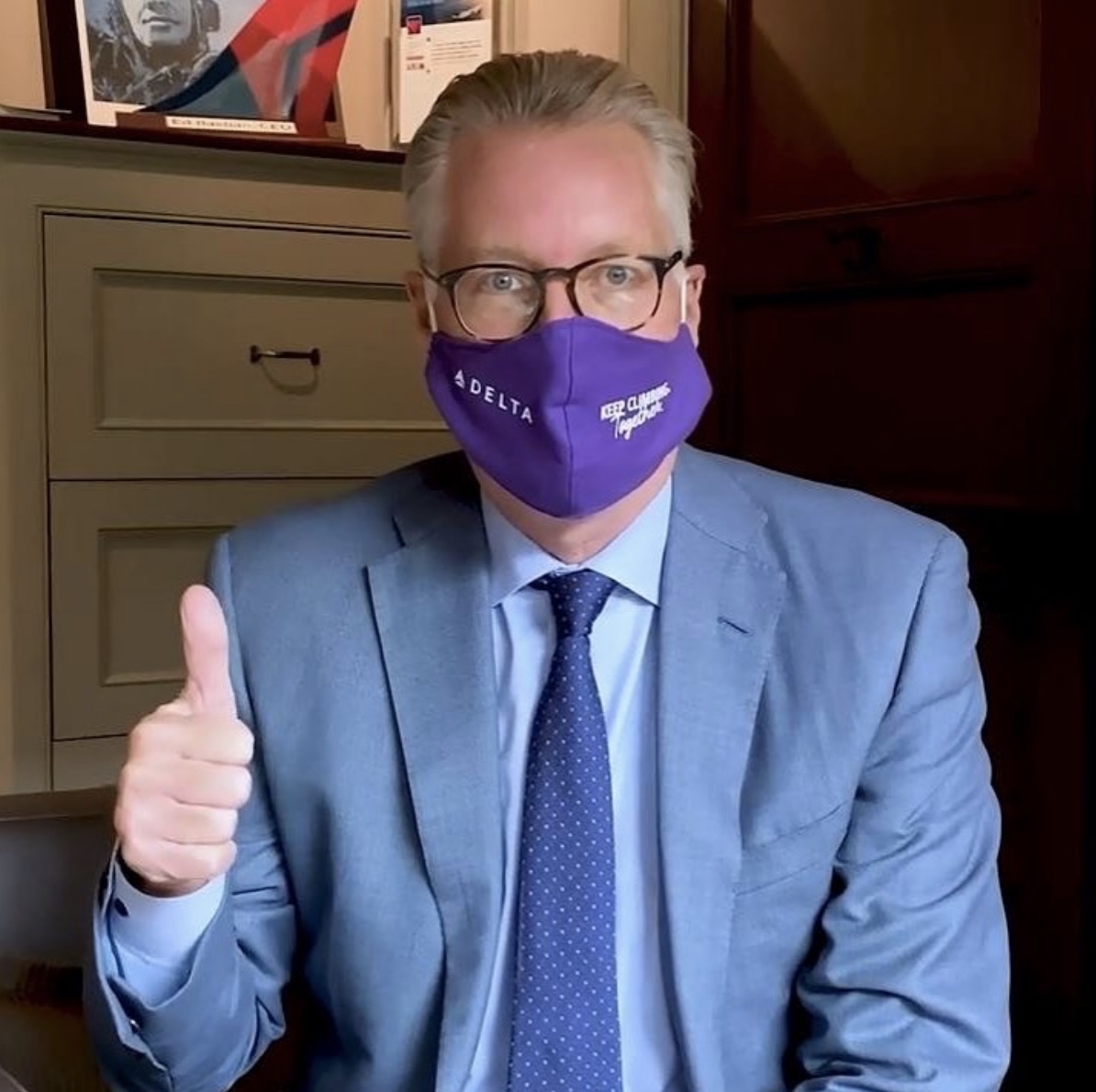 a man wearing a purple face mask